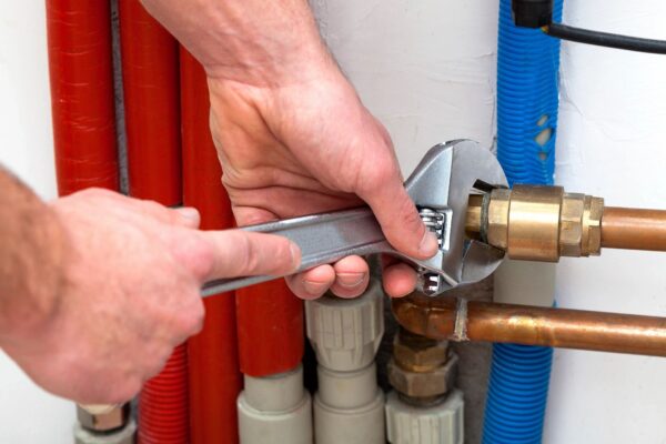 Colorado homeowner shutting off water supply during plumbing emergency.